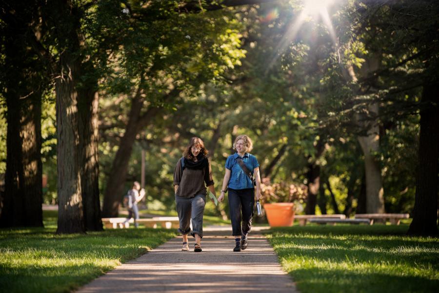 Beloit College students walk down one of the park-like walkways in the Beloit College campus.